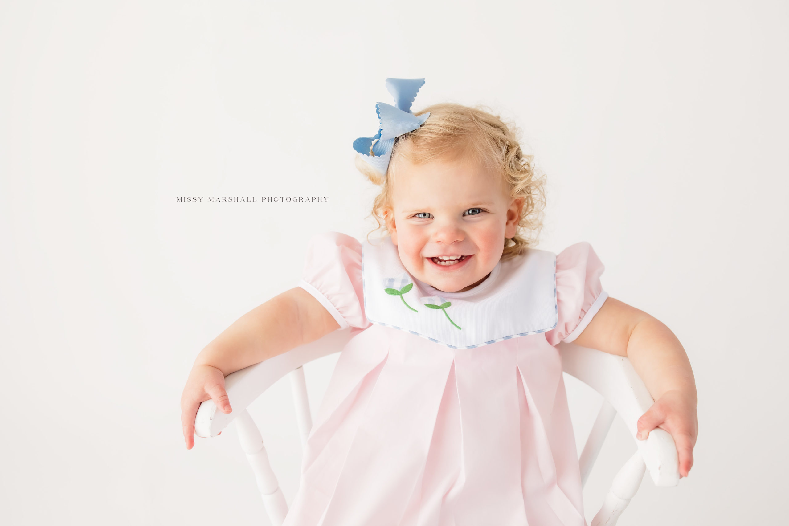 Close up of baby girl smiling at a Louisville baby photographer during her milestone session