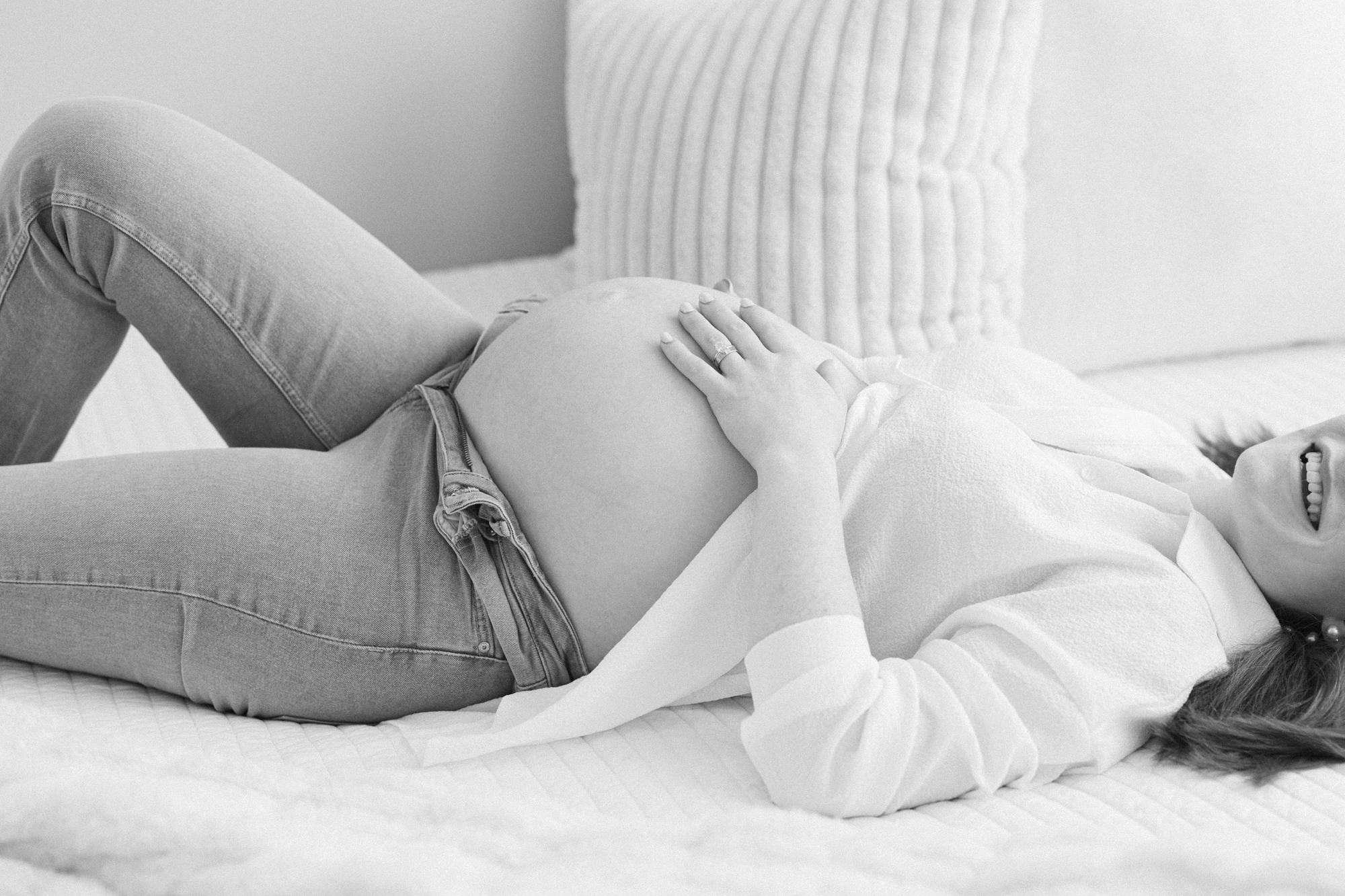 Black and white portrait of a pregnant mom laying on her back with her belly exposed taken by Louisville KY maternity photographer Missy Marshall